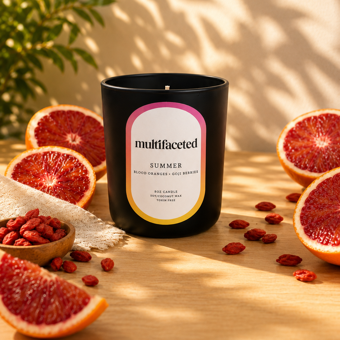 Multifaceted Summer candle with grapefruits and goji berries on a wooden surface